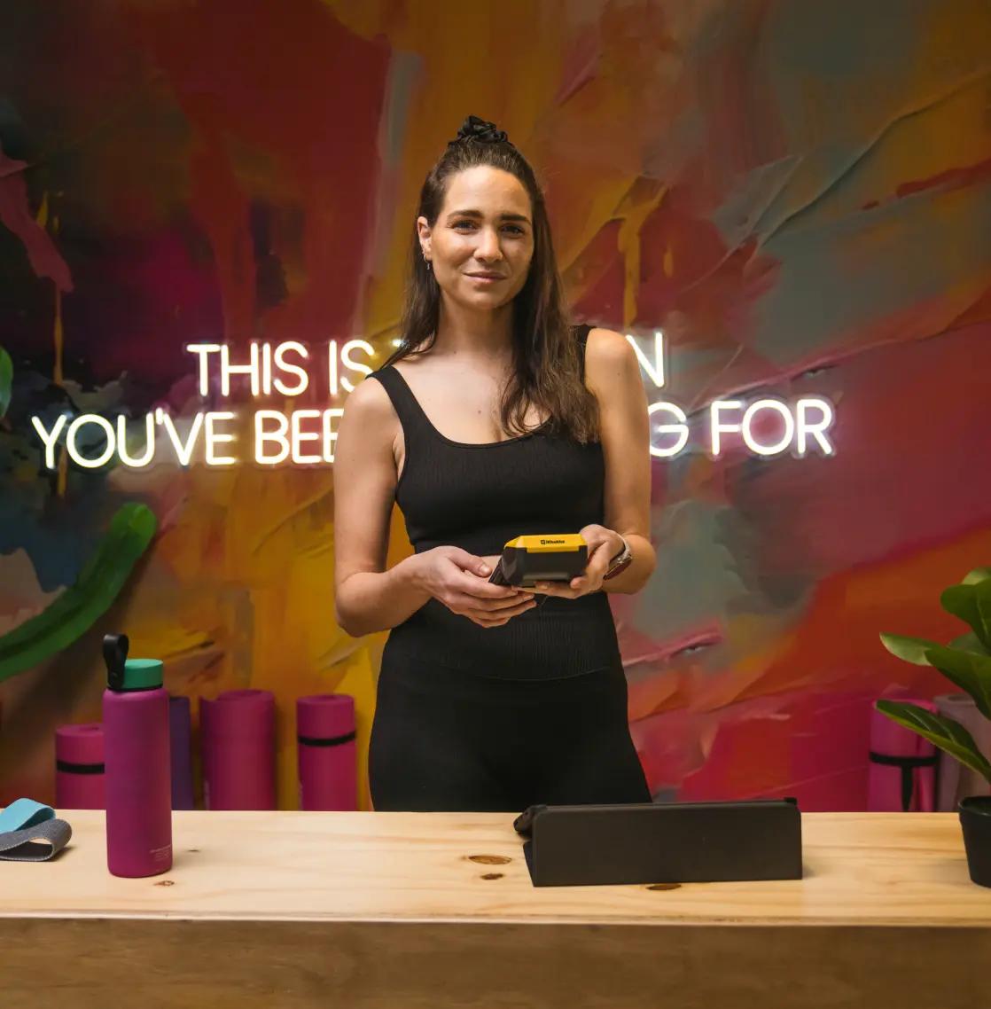 Woman holding iKhokha card machine