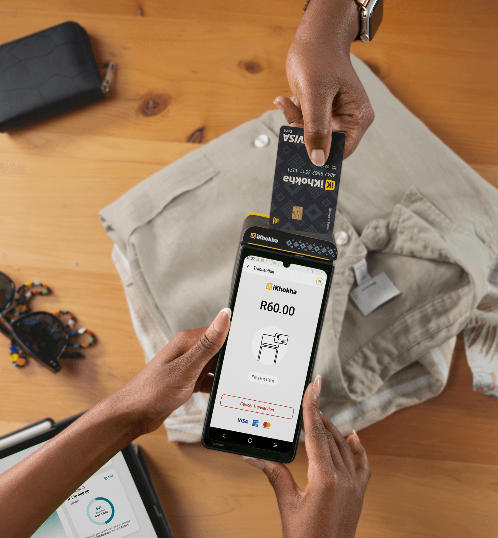 Woman holding iKhokha card machine in store