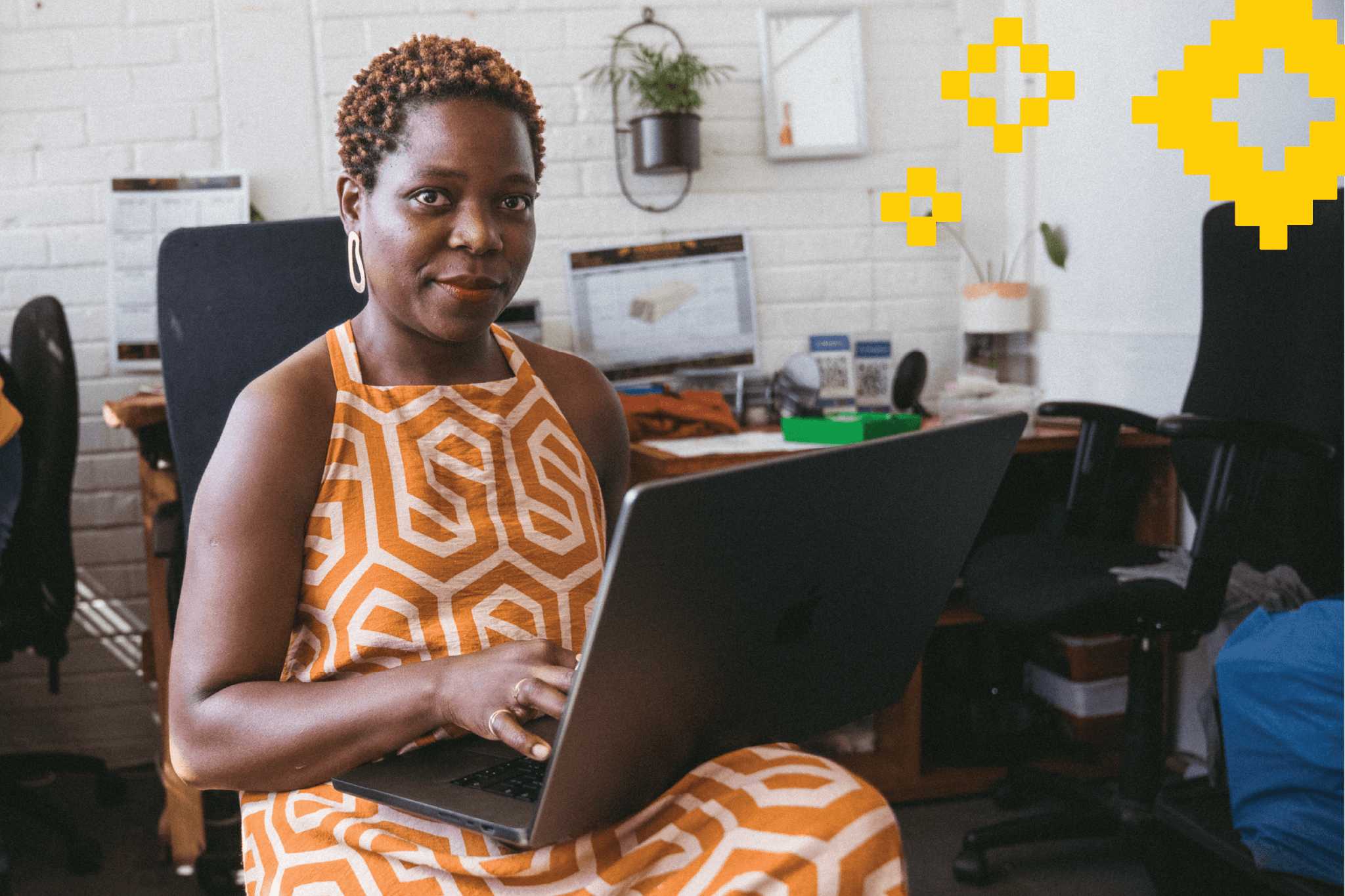 Lady sitting on chair with laptop on lap building a website